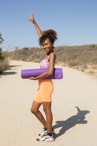 Girl holding color dusk yoga mat